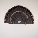 Kabash Outdoors American steel turkey fan display hanger. Fan holder is textured black with a turkey silhouette cutout. It is holding a beautiful turkey tail.