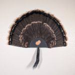 Kabash Outdoors American steel turkey fan display hanger. Fan holder is textured black with a turkey silhouette cutout. It is holding a beautiful turkey tail and beard.
