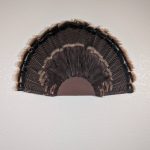 Kabash Outdoors American steel turkey fan display hanger. Fan holder is rustic brown with a classic scalloped edge design. It is holding a beautiful turkey tail.