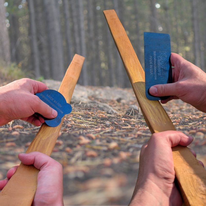 Kabash Outdoors card scrapers for bow building. The are both styles being shown scraping an Osage Orange bow stave.